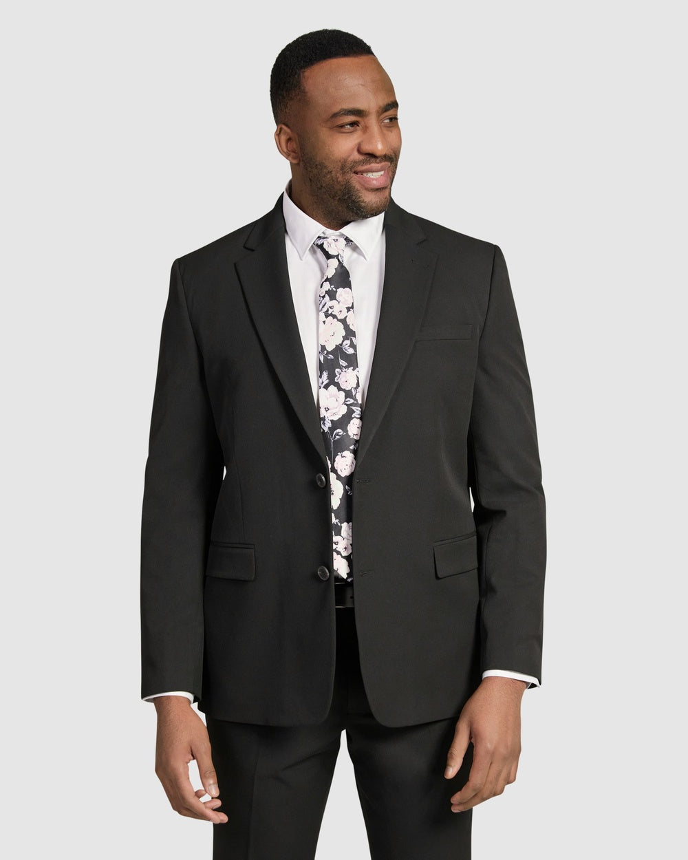 A more conservative, black blazer that fits closely over shoulder with moderately tapered waist