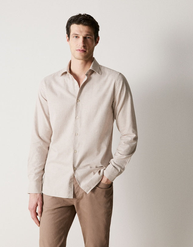 A more formal beige shirt that will fit with curated look.